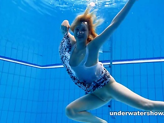 Cute lucie is stripping underwater
