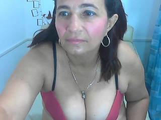 Stacked milf in a pink bra lies in bed to masturbate on web