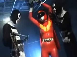 Sexy Super Hero In Orange Latex Is Tortured B...