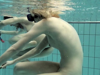 Girls swimming underwater and enjoying eachother...