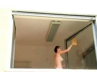 Short haired girl washes windows topless...