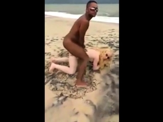 They take turns taking dick on the beach