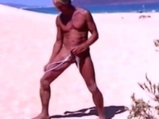 Tanned guy on beach in tiny string thong (temporarily!)