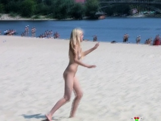 Adorable nudist teen sunbathes nude