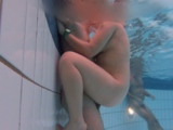 A young Latin couple has sex underwater in a public pool
